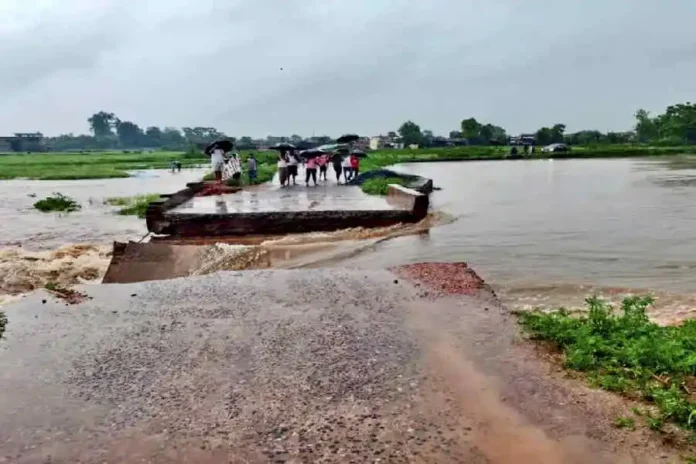 People stand near the part of a local bridge that was washed away following heavy rainfall, disrupting local connectivity, in Latehar district of Jharkhand, Monday morning, June 30, 2025. PTI picture.