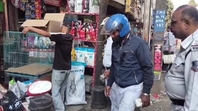 Traffic police clear sidewalks on Bidhan Road as part of a special drive against encroachments by shopkeepers. Tuesday, 02 December 2025.