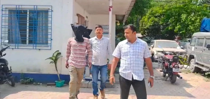 Police escort the two arrested youths to Jalpaiguri court following their detention with a firearm in Siliguri ahead of the elections. Wednesday, 18 March 2026.