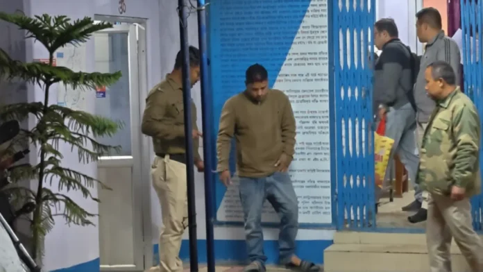Fraud accused from Chopra seen in police custody after being arrested from Siliguri’s Ashighar Outpost area. Sunday, 22 March 2026.