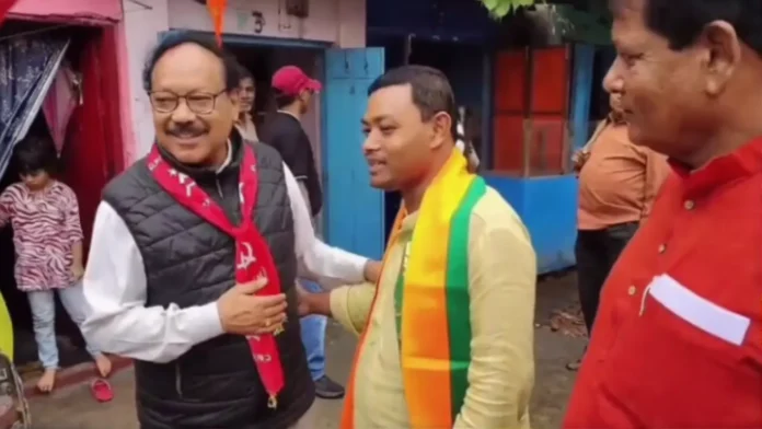 BJP candidate Anandamay Barman and CPI(M) candidate Jharen Roy exchange greetings during a campaign trail encounter in Bagdogra. Sunday, 29 March 2026.