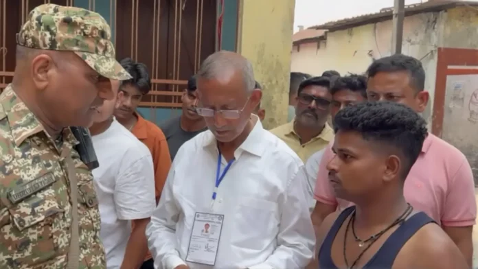 Polling officials interact with a voter at a Siliguri booth after he alleged his vote had already been cast, triggering confusion during voting. Thursday, 23 April 2026.