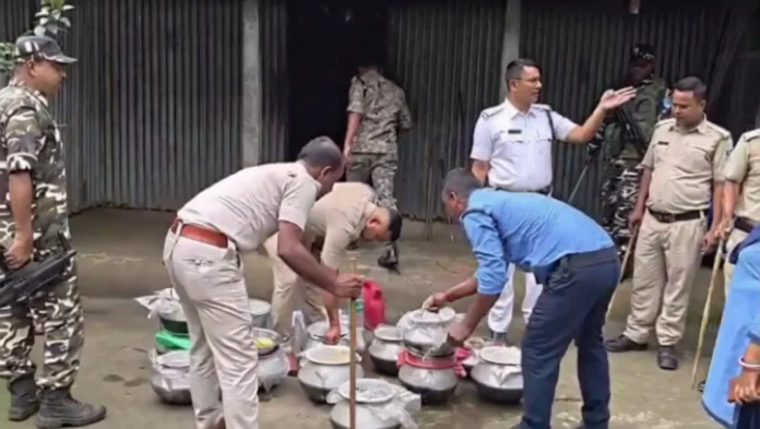 Excise officials and police personnel during a joint raid against illegal country liquor units in Sumribhita village of Rajganj on Wednesday, 27 May 2026.